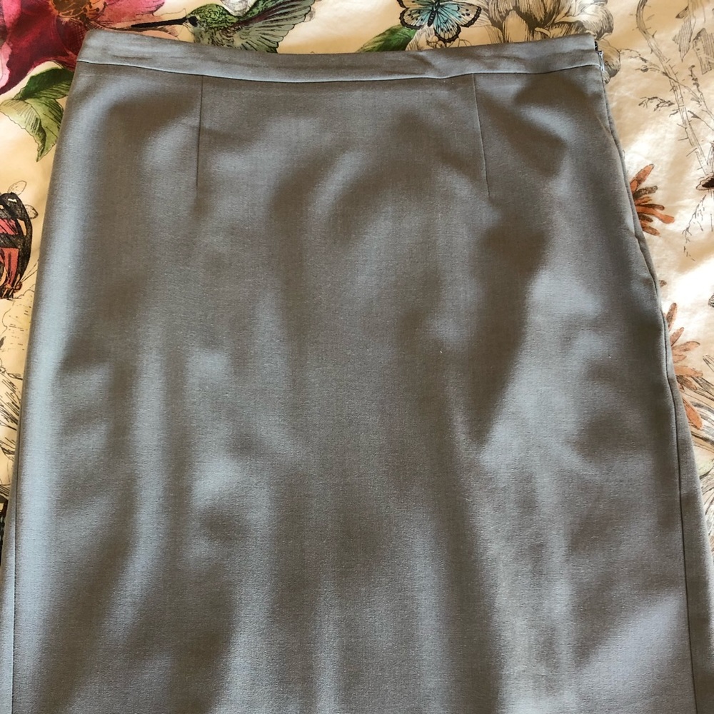 Business attire gray midi skirt with back detail.